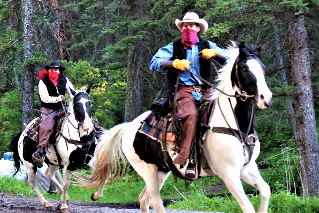 The outlaws try to stop the wagons from getting to the chuck wagon dinner up Cache Creek Canyon.