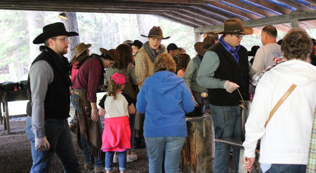 Our Guests going through the chow line at camp at the Bar T 5 Covered Wagon Cookout & Show.