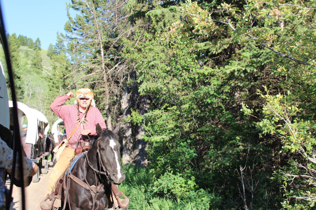 Our mountain man, Buckskin, warns the wagons of danger up ahead. The wagons forge ahead to the chuck wagon dinner.