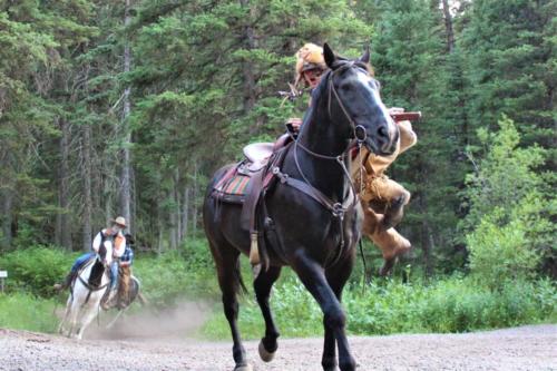 Buckskin Dismounting Followed By The Outlaws