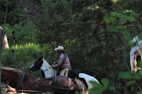 An Outlaw Riding Past a Wagon